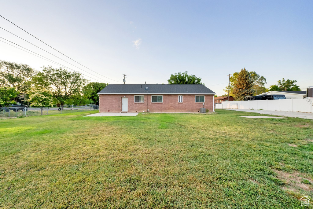 Back of house featuring a patio and brick siding