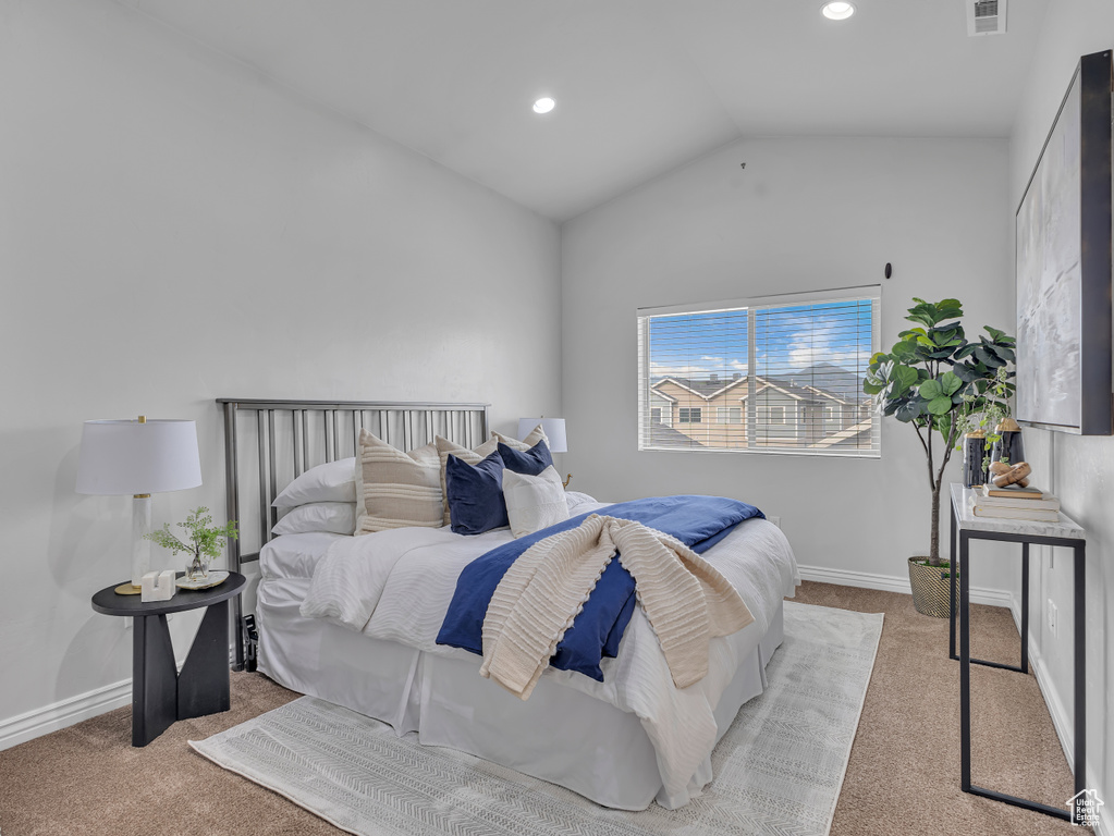 Carpeted bedroom with lofted ceiling, baseboards, and recessed lighting