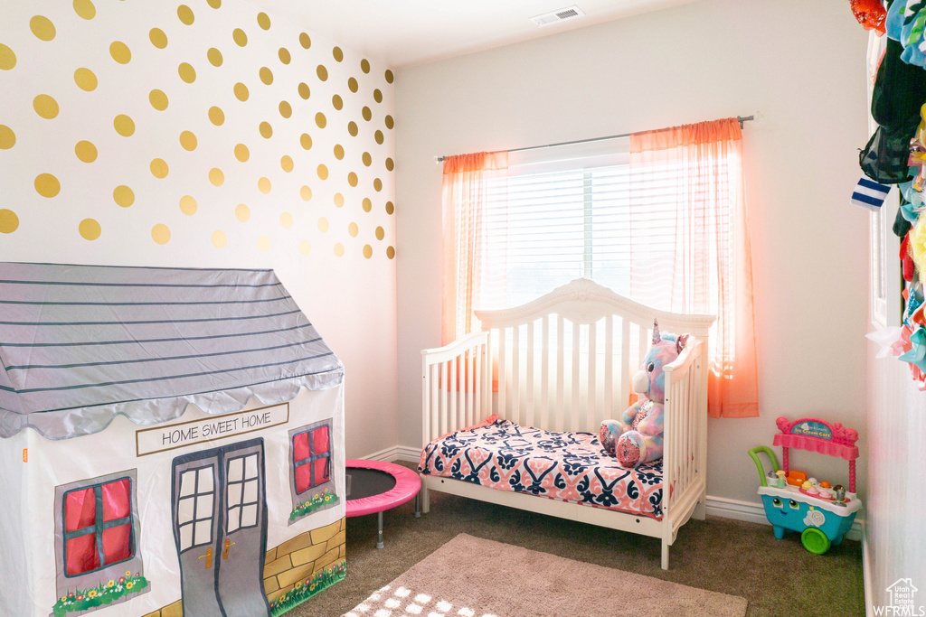 Carpeted bedroom with wallpapered walls and baseboards