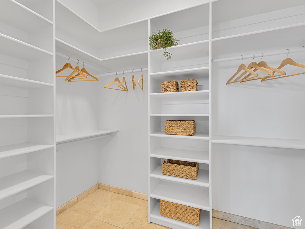 Walk in closet with tile patterned floors
