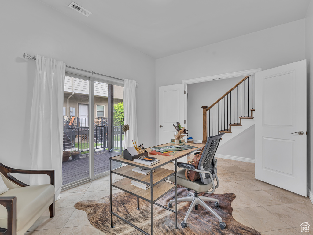 Office area featuring light tile patterned floors