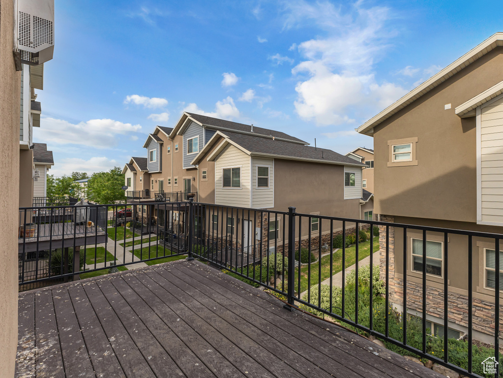 Wooden terrace featuring a residential view