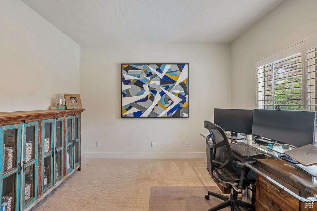 Carpeted office featuring baseboards