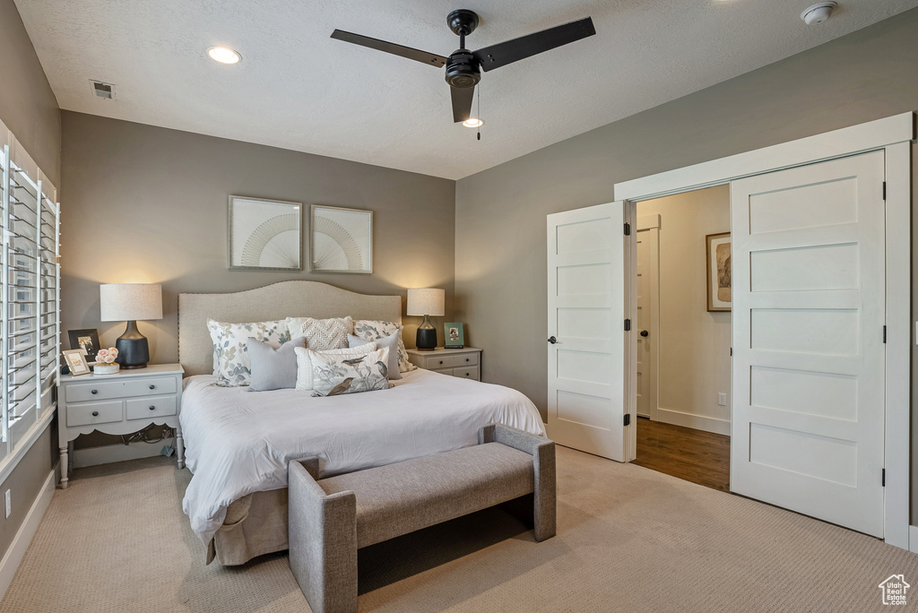 Bedroom with light carpet, a ceiling fan, baseboards, and recessed lighting