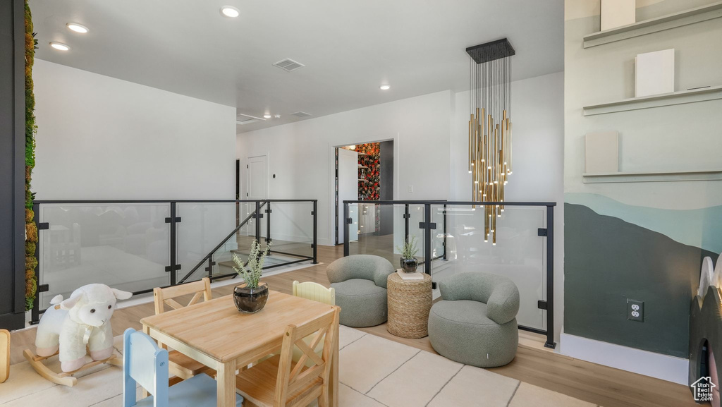 Living area with wood finished floors and recessed lighting
