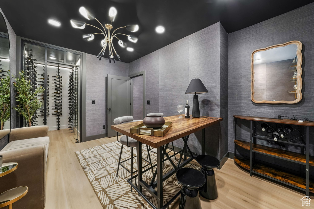 Home office with wood finished floors and a chandelier
