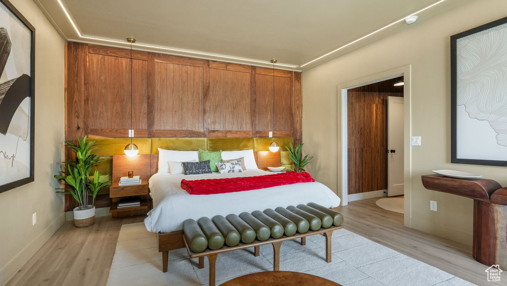 Bedroom with light wood-style flooring and baseboards
