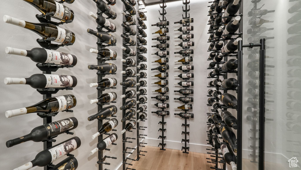 Wine room featuring wood finished floors