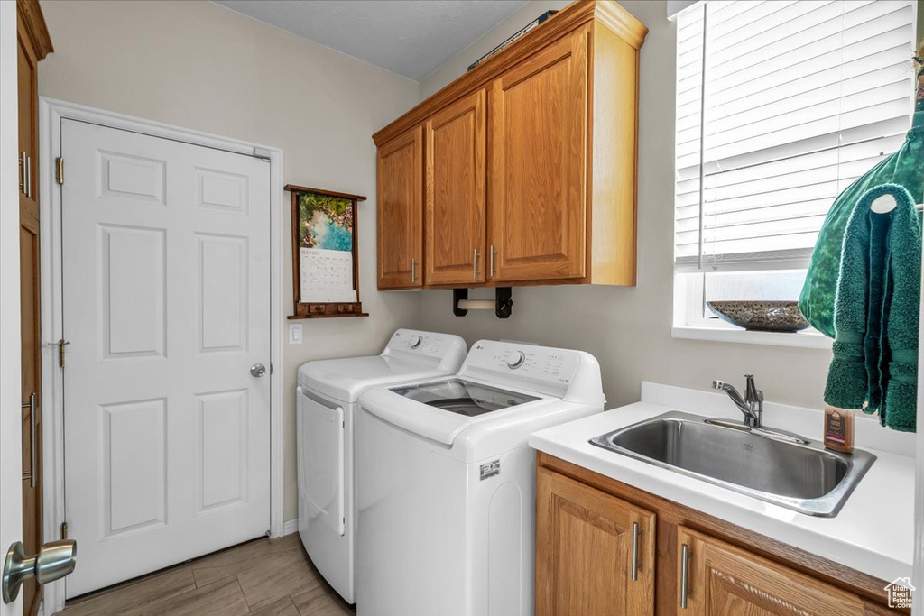 Laundry room featuring washer and dryer and cabinet space