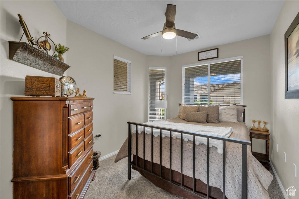Bedroom with carpet flooring, baseboards, and ceiling fan