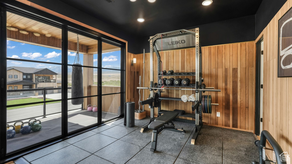 Exercise area with wooden walls and recessed lighting