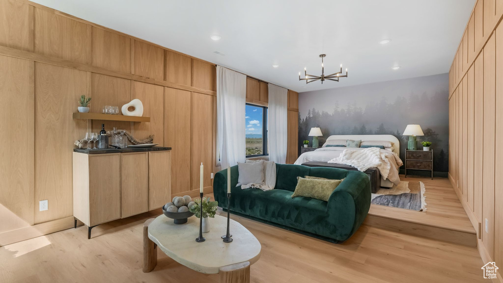 Bedroom with light wood-type flooring, a chandelier, and recessed lighting