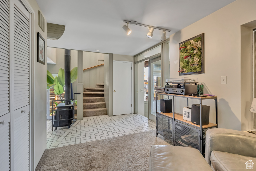 Sitting room with healthy amount of natural light, stairway, and rail lighting