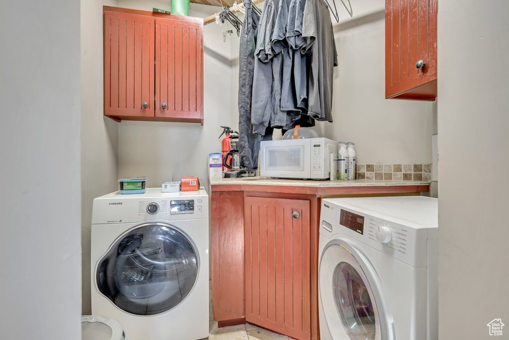 Laundry room featuring cabinet space and separate washer and dryer