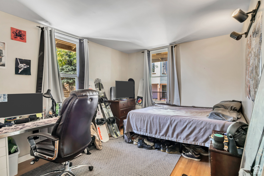 Bedroom featuring wood finished floors and a desk