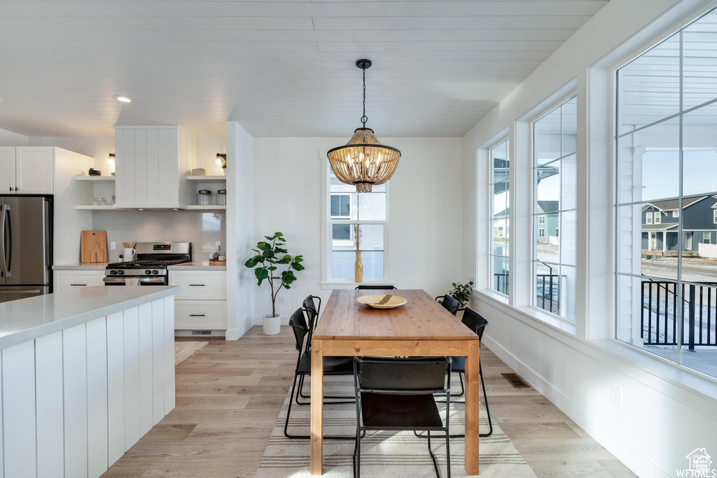 Dining space featuring a chandelier, light wood finished floors, and recessed lighting