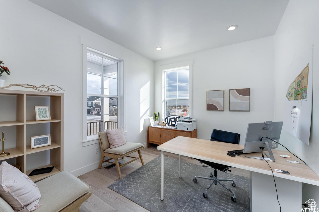 Home office featuring light wood-style flooring, baseboards, and recessed lighting