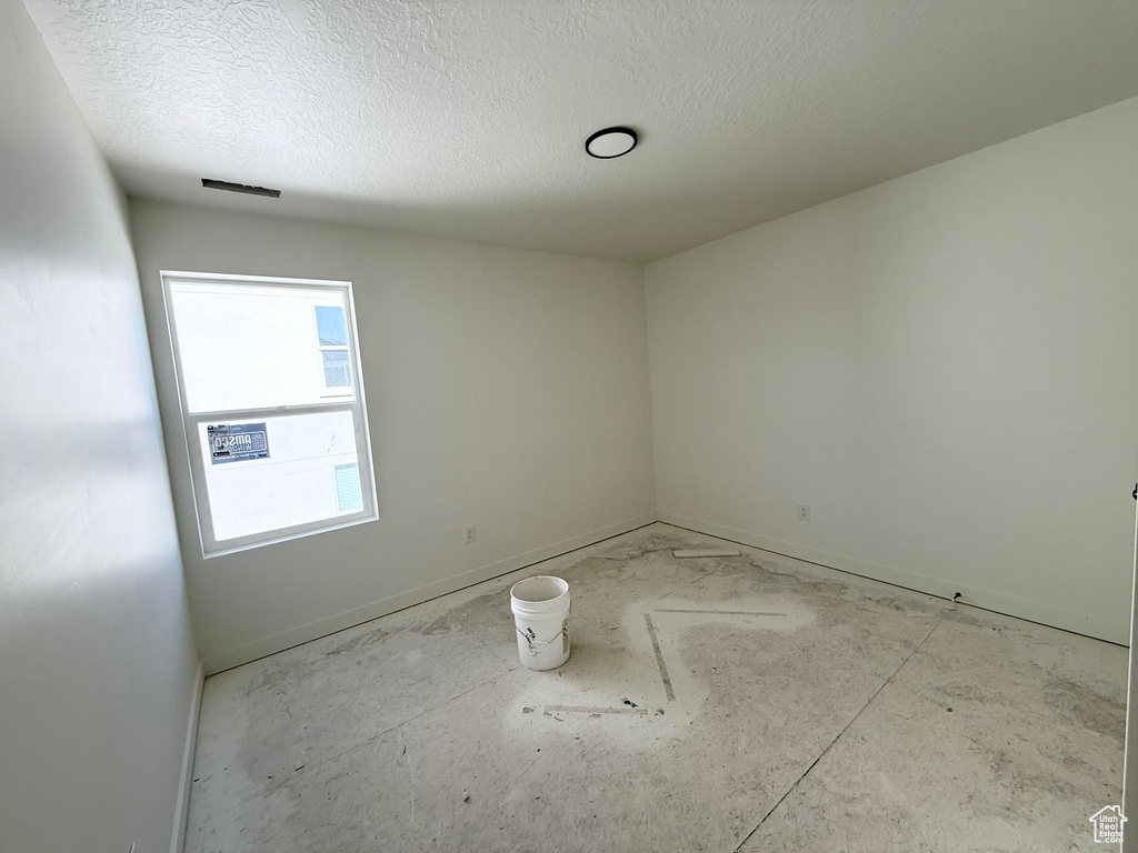 Spare room with a textured ceiling