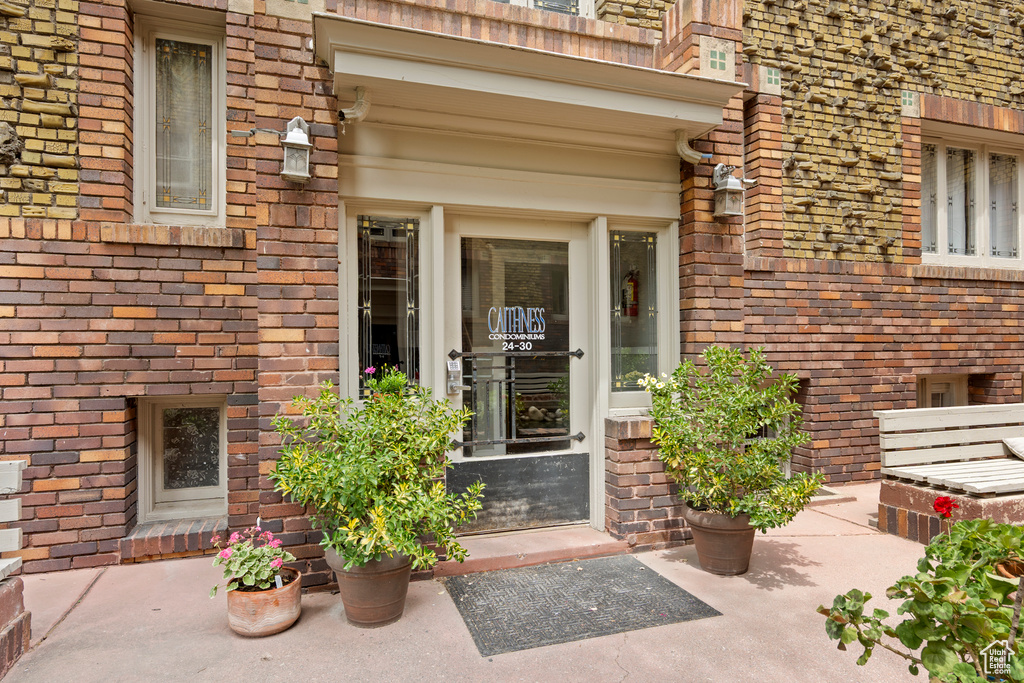 Property entrance featuring brick siding