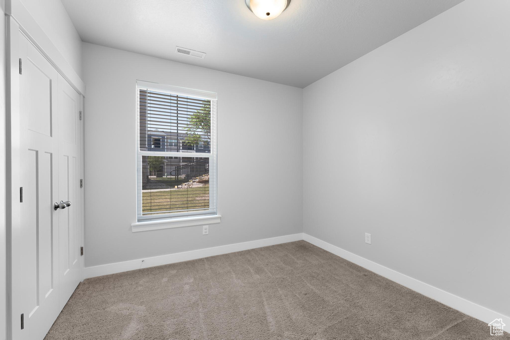 Unfurnished bedroom featuring carpet floors and baseboards