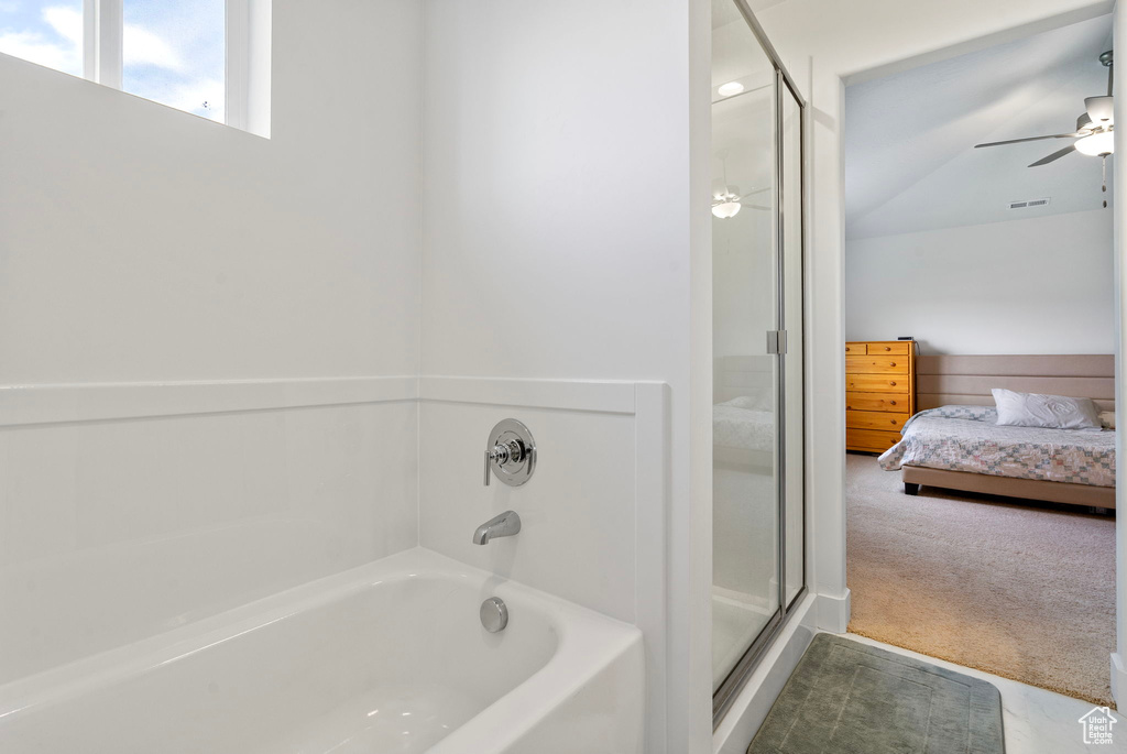 Full bathroom featuring ensuite bathroom, a garden tub, a stall shower, and ceiling fan