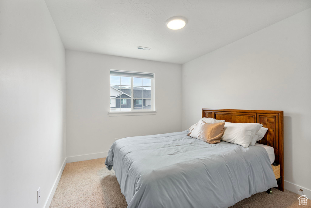 Carpeted bedroom featuring baseboards
