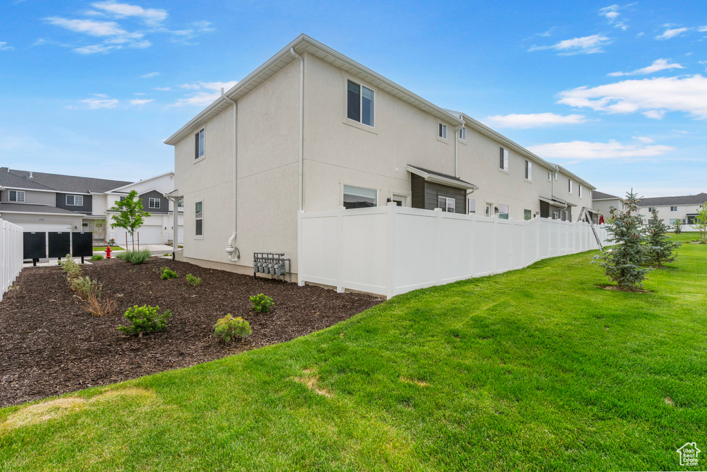 Rear view of property featuring stucco siding and a residential view