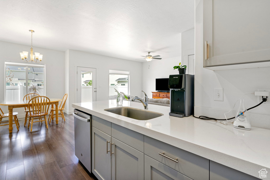 Kitchen featuring a sink, gray cabinetry, stainless steel dishwasher, ceiling fan, and dark wood-style floors