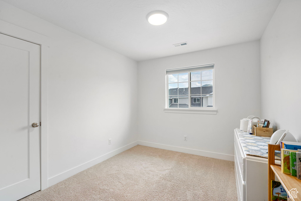 Unfurnished bedroom featuring carpet and baseboards