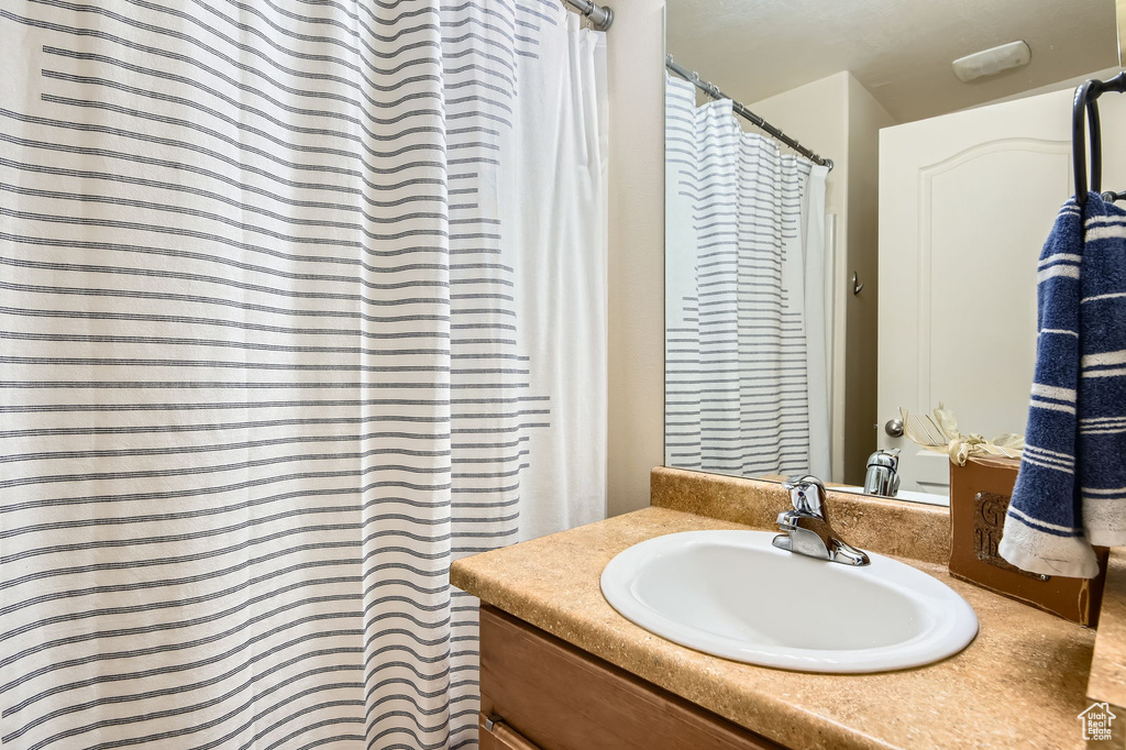 Full bath with vanity and curtained shower