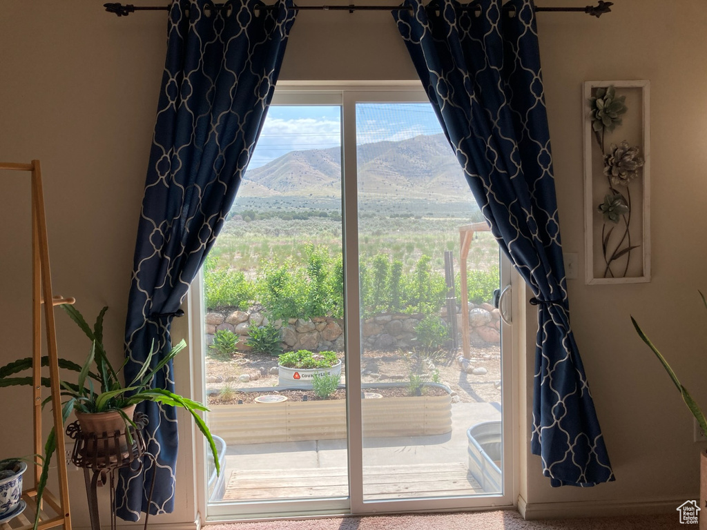 Doorway to outside featuring a mountain view