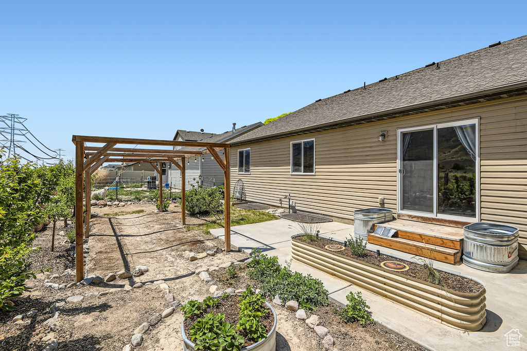 Fenced backyard with a patio area and entry steps