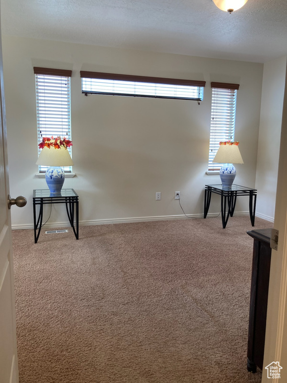 Spare room with carpet and baseboards