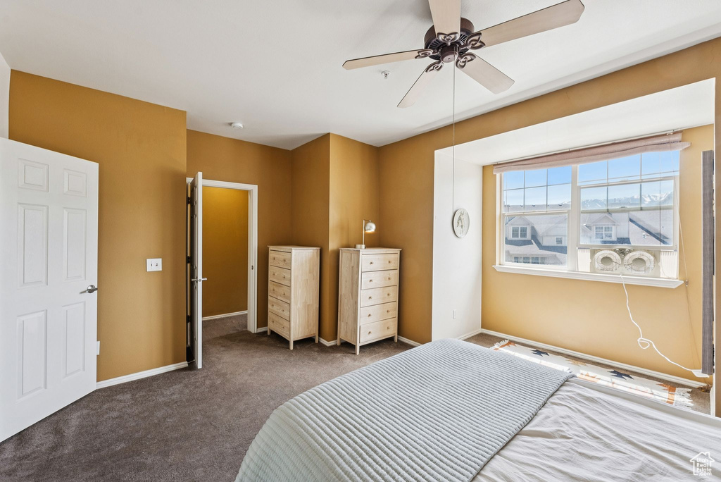 Carpeted bedroom with baseboards and ceiling fan