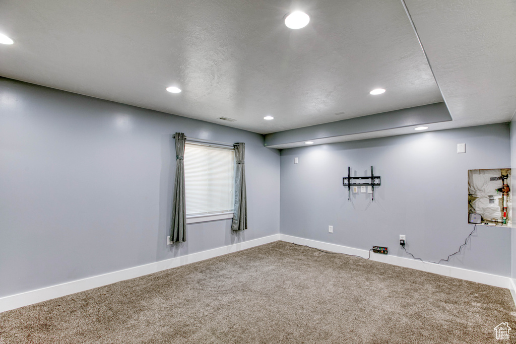 Empty room with carpet, recessed lighting, and baseboards