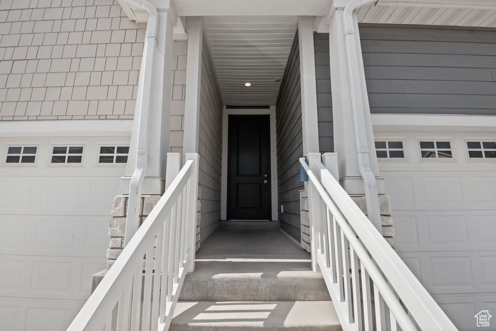 Doorway to property with a garage