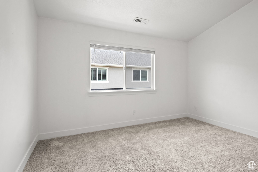 Spare room with carpet and baseboards