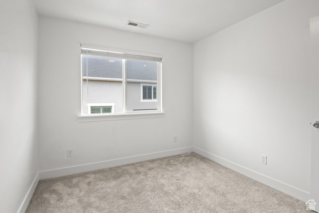 Unfurnished room featuring carpet floors and baseboards