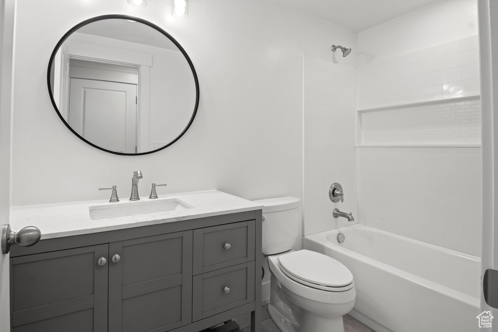 Bathroom featuring toilet, vanity, and tub / shower combination