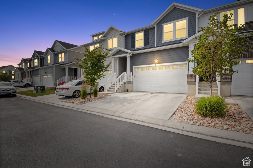 Townhome / multi-family property featuring an attached garage and driveway