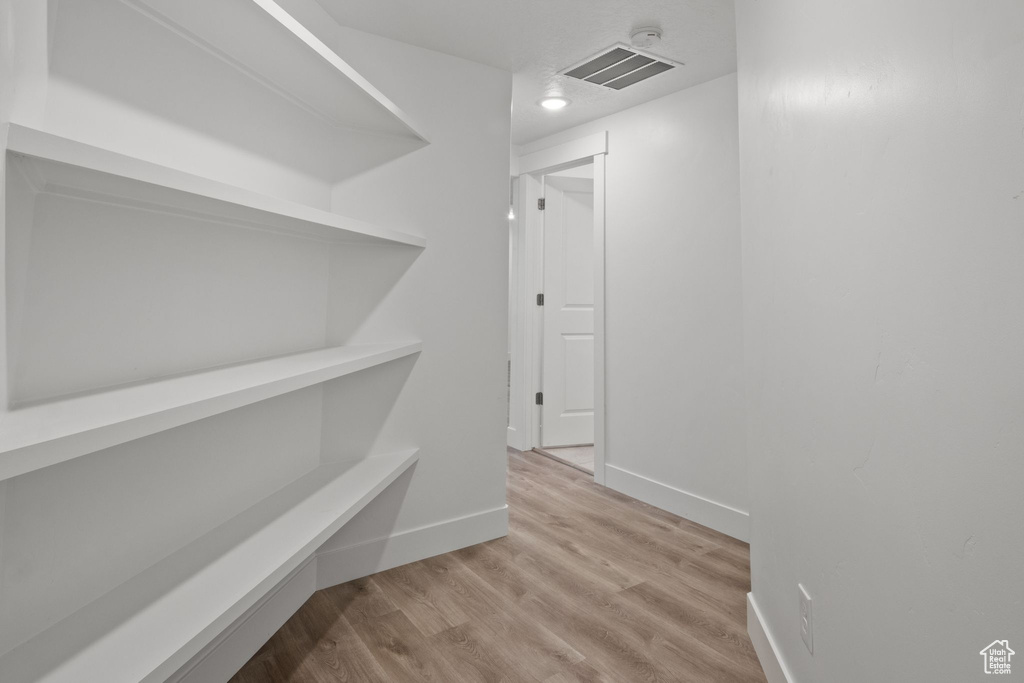 Hall with wood finished floors and baseboards