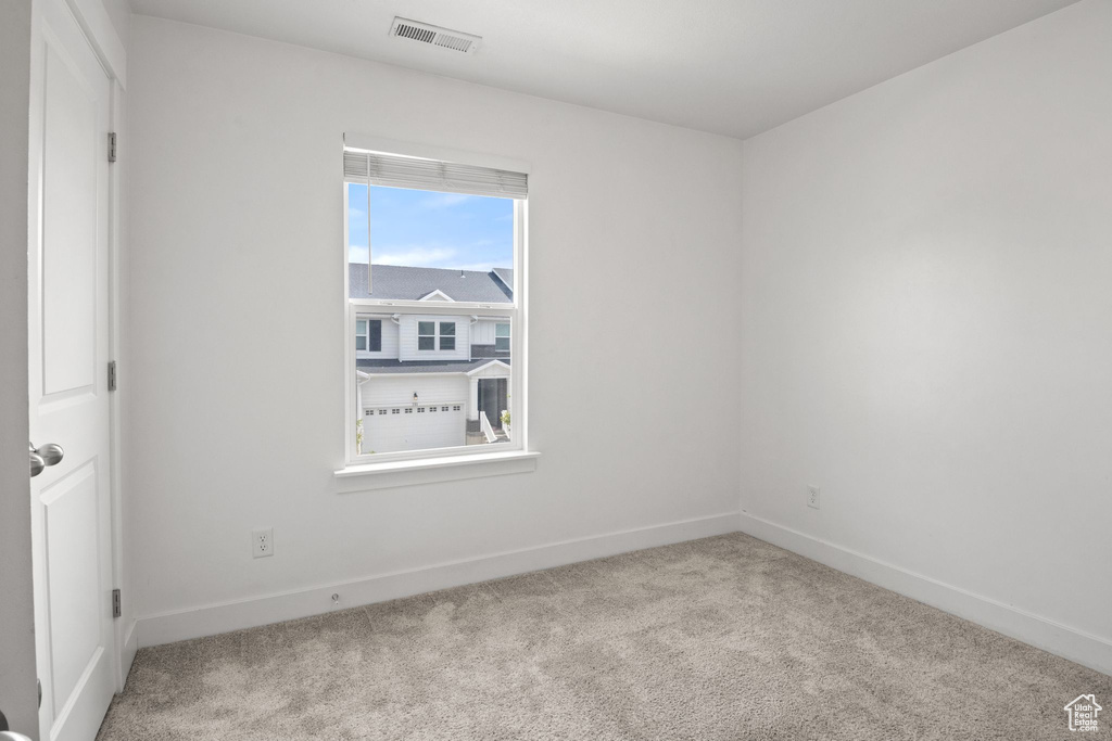Unfurnished room with carpet floors and baseboards