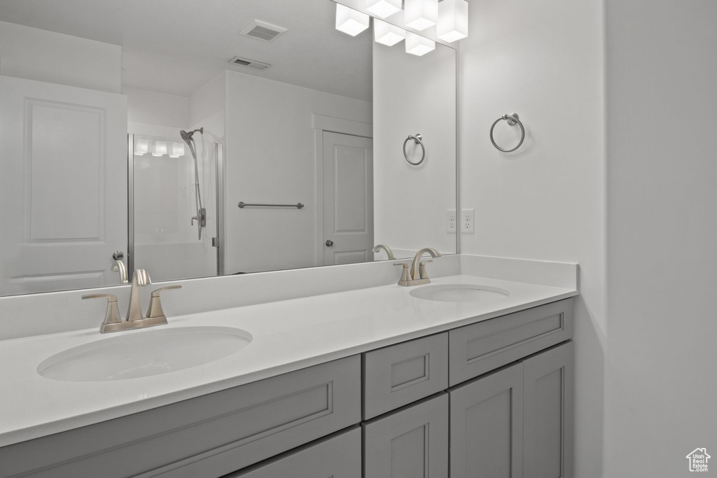 Bathroom with double vanity and a shower