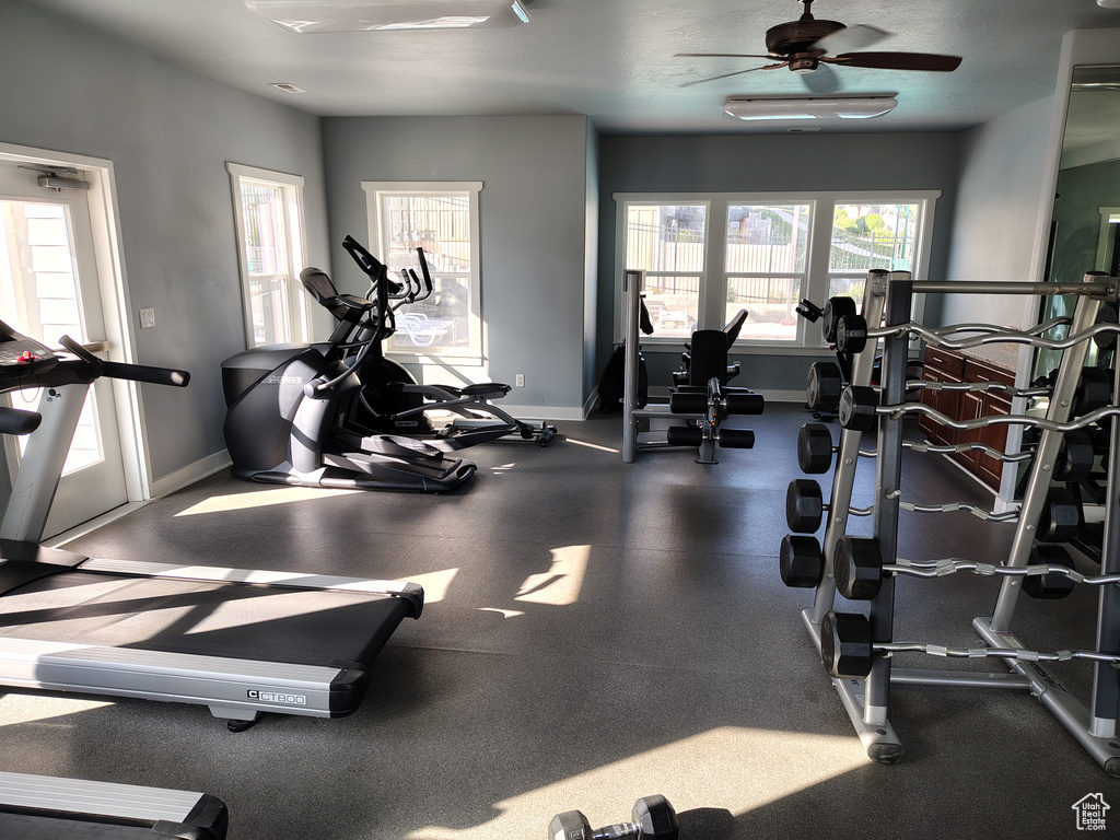 Gym featuring baseboards and a ceiling fan