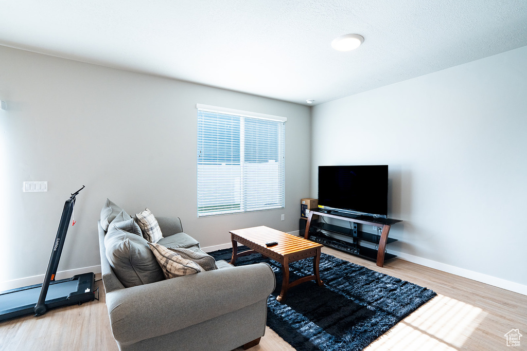 Living area with light wood-style flooring and baseboards
