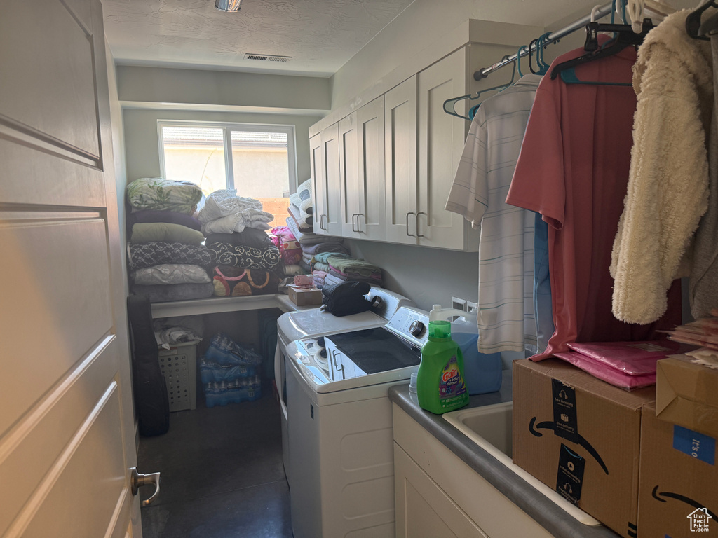 Laundry area with washer and clothes dryer and cabinet space