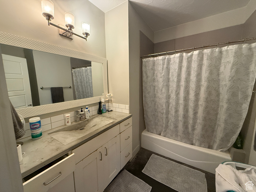 Full bath featuring vanity and shower / bath combo with shower curtain