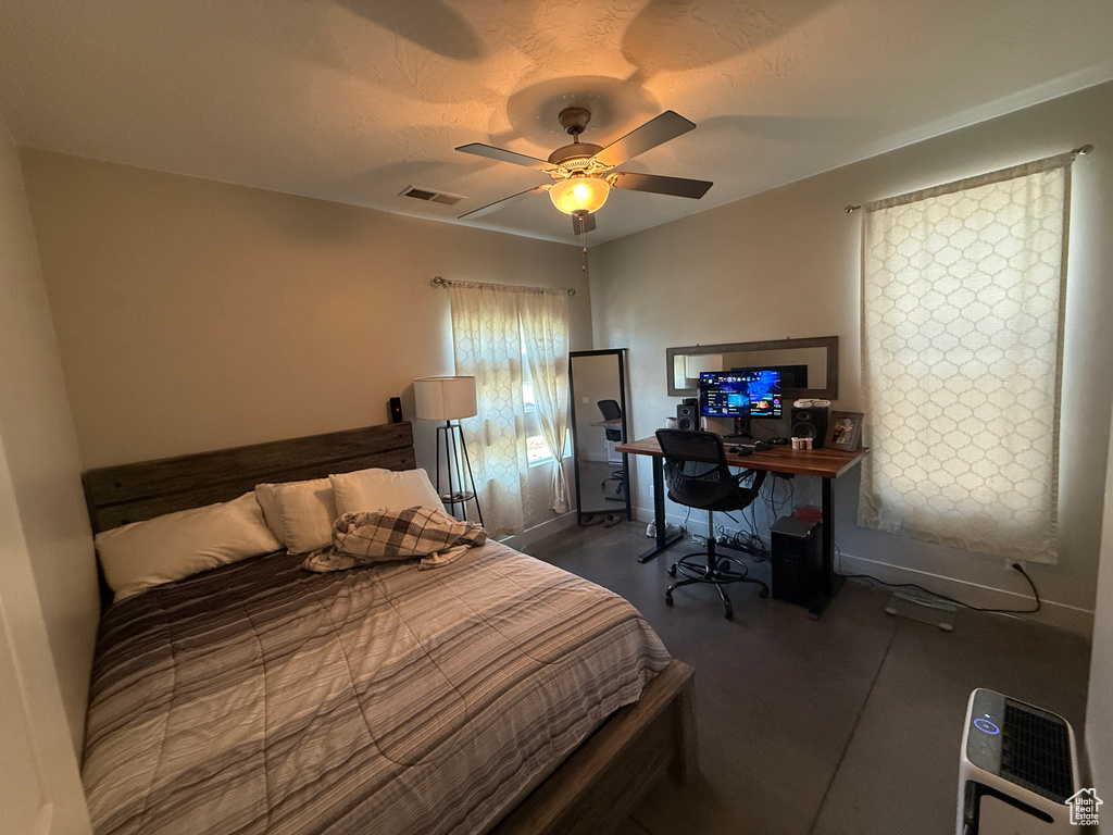 Bedroom featuring a ceiling fan and an office area