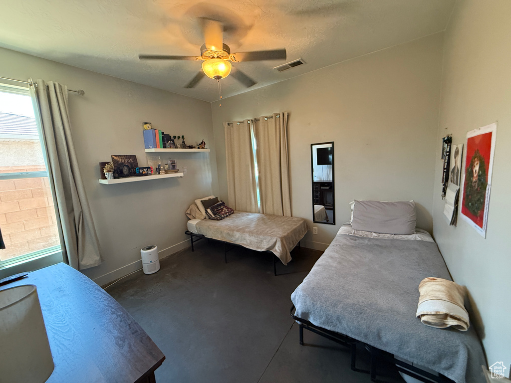 Carpeted bedroom with baseboards and a ceiling fan