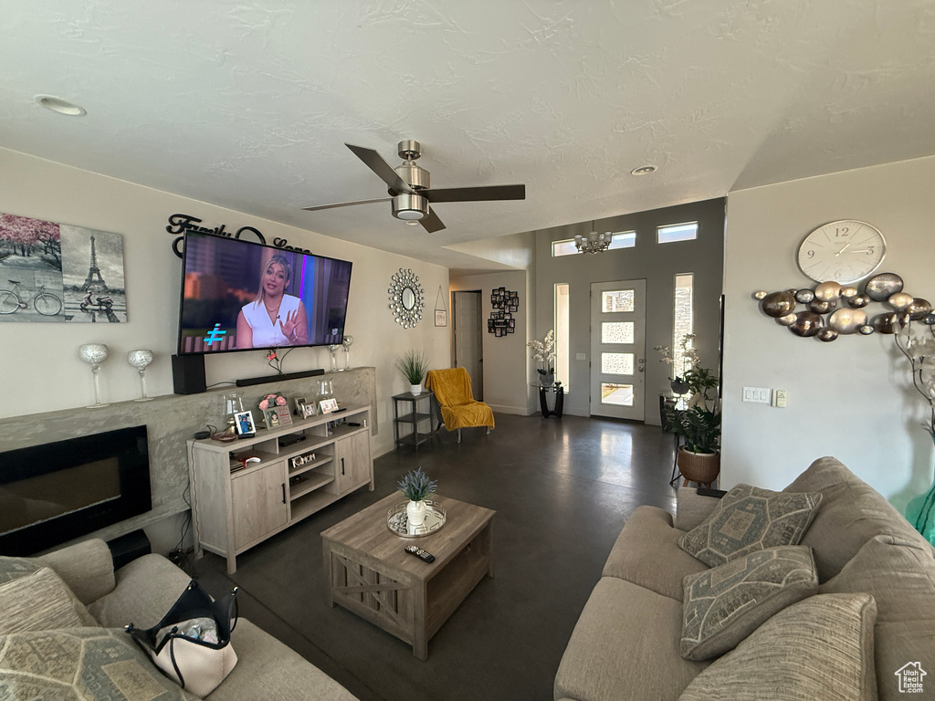 Living area featuring ceiling fan and a high end fireplace